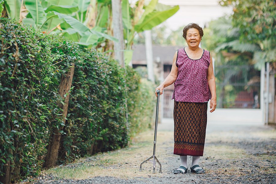 fall immediate care - elderly lady walking with walking stick