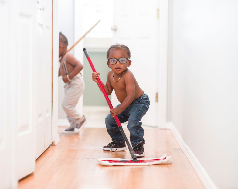 cleaning habit for kids - toddler holding a mop